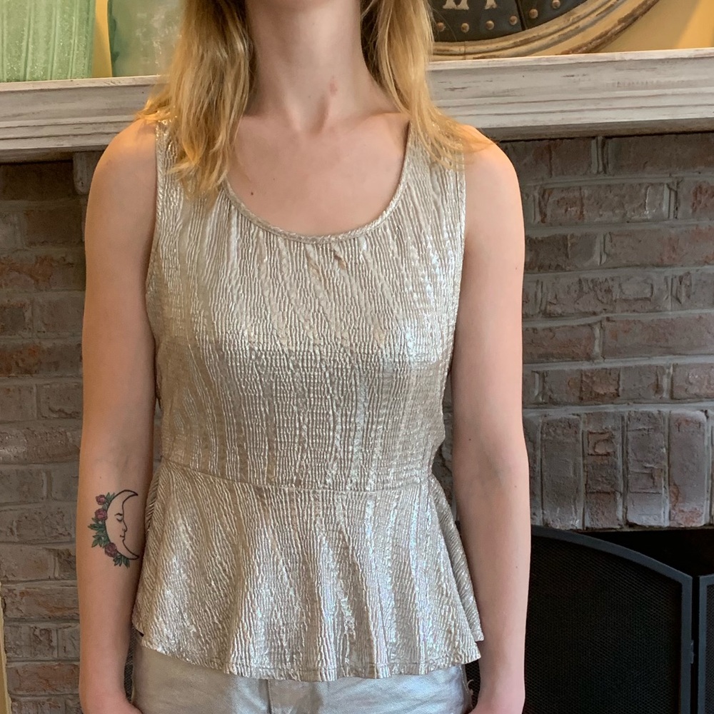 Tank top with peplum in shimmery metallic lame. Perfect for holiday